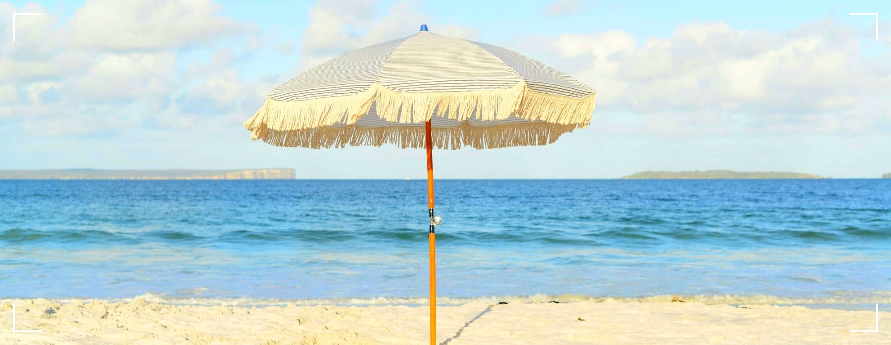 white umbrella on seashore